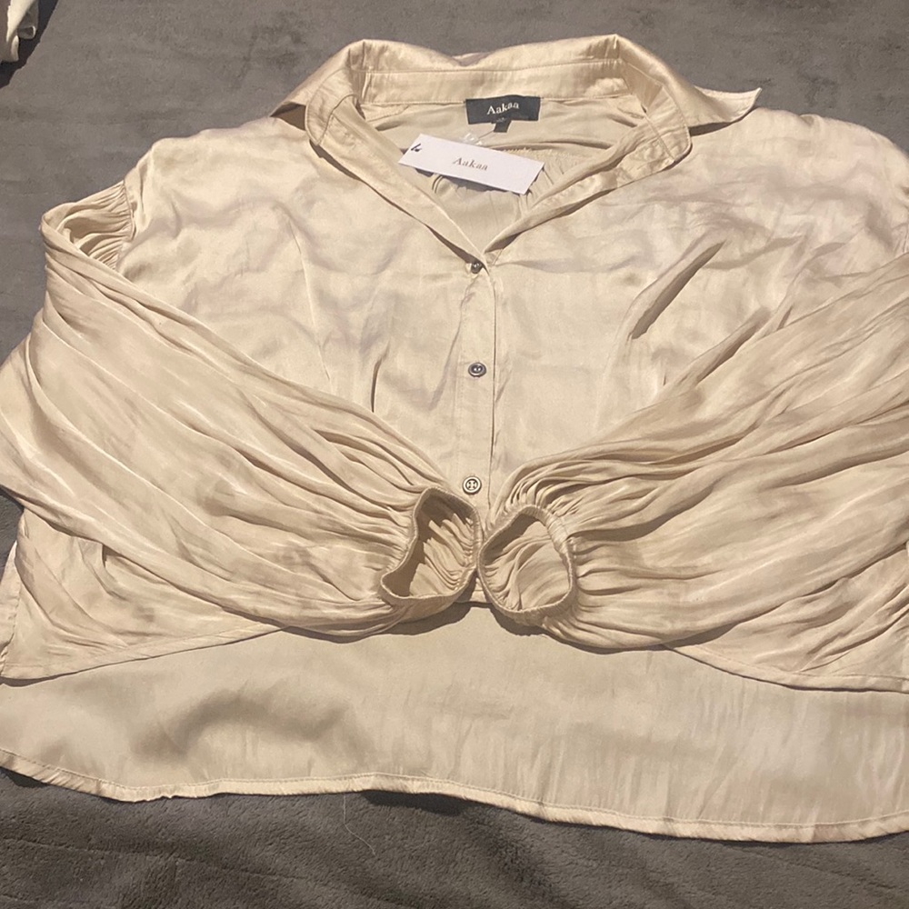 Cream silk blouse with buttons. Never worn. Tags still attached. Size medium